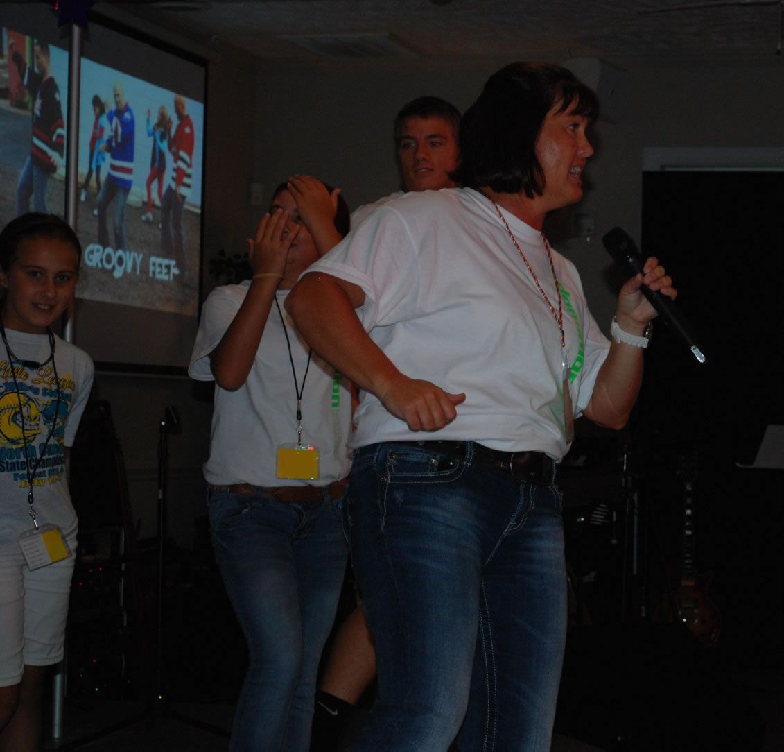 A group of people standing in front of a screen that says gloom