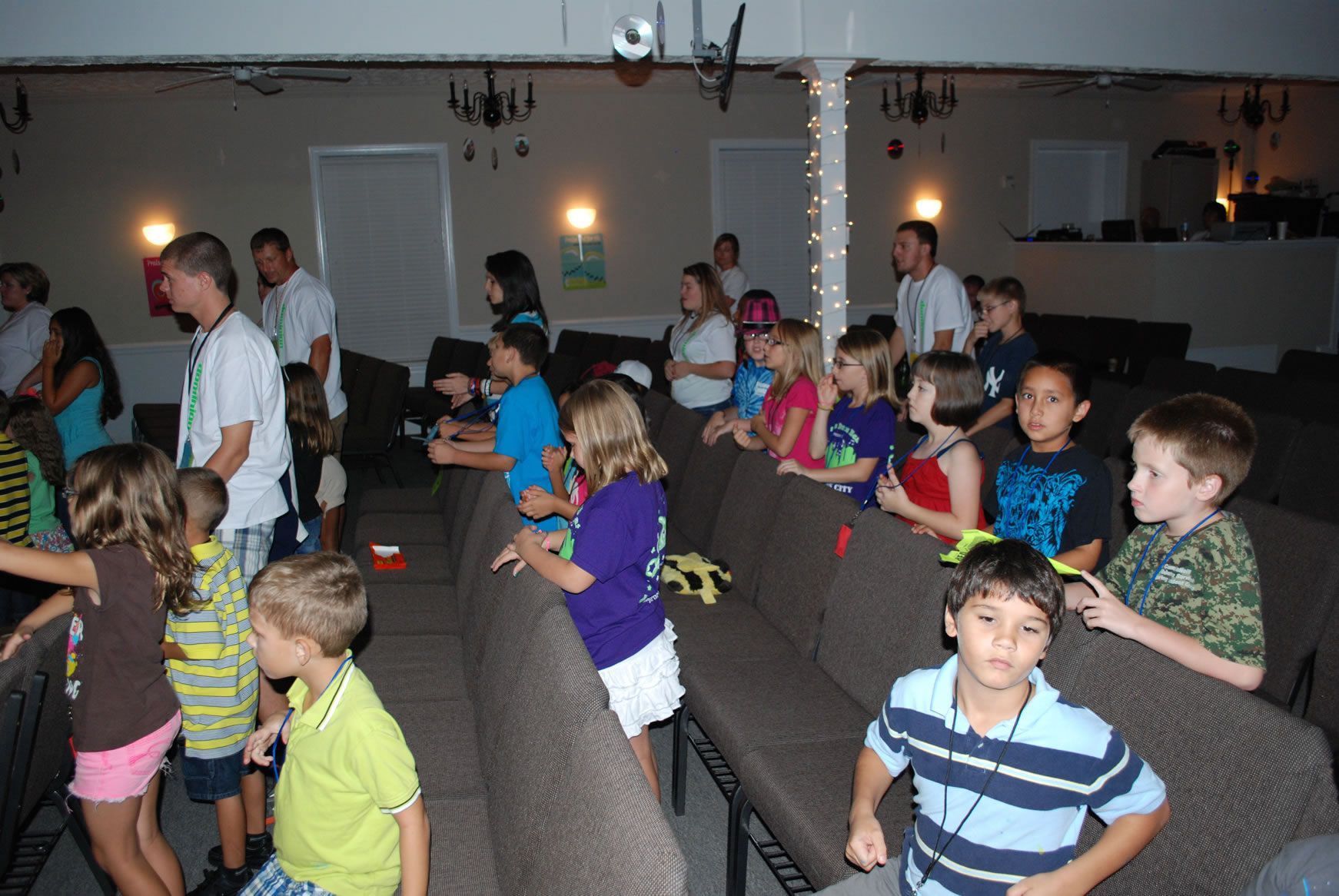 A group of children are sitting in chairs in a room