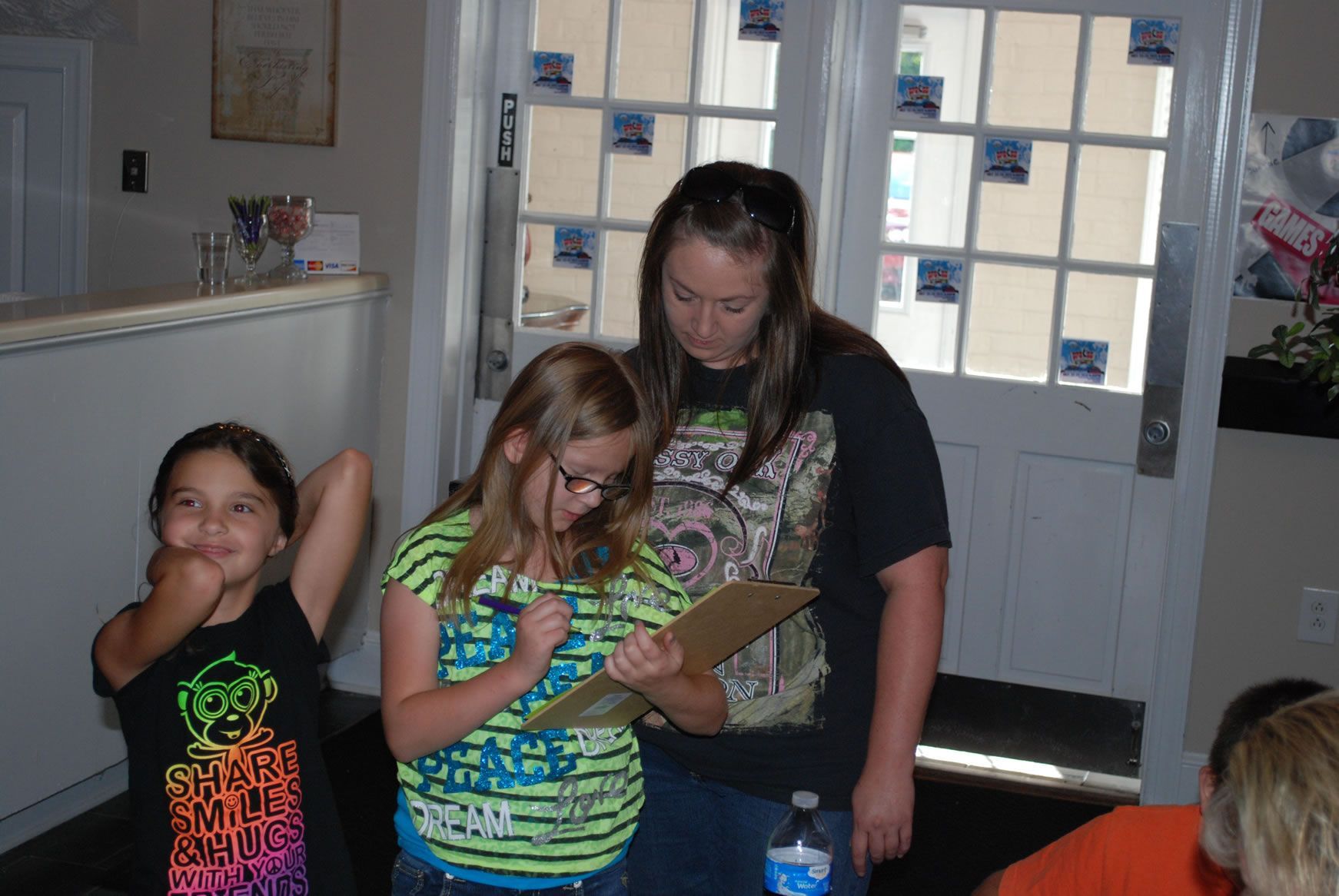 A girl wearing a shirt that says ' shark ' on it