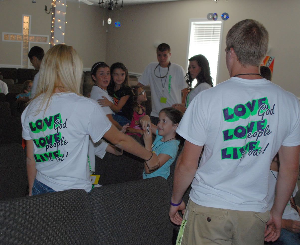 A group of people wearing shirts that say love god love people live