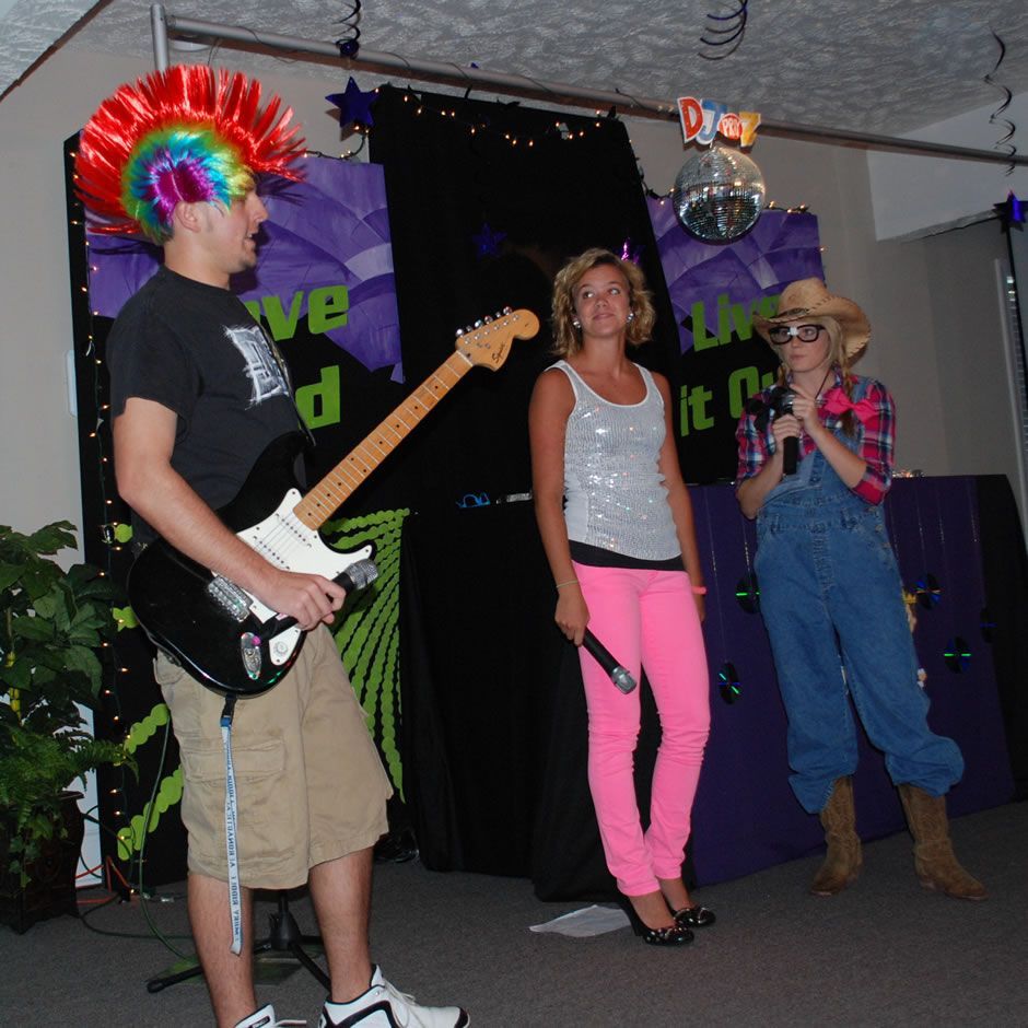 A man with a mohawk is playing a guitar
