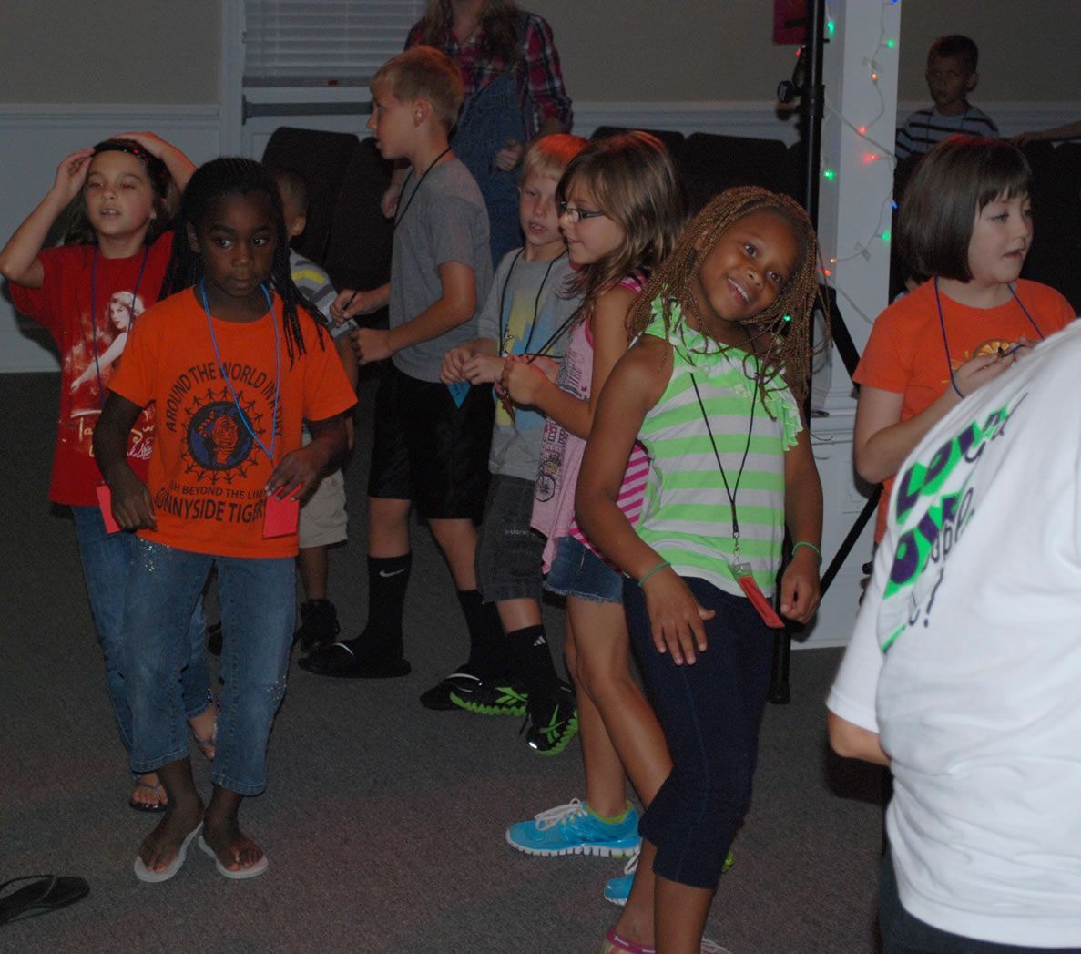 A girl wearing an orange shirt that says ' new york ' on it