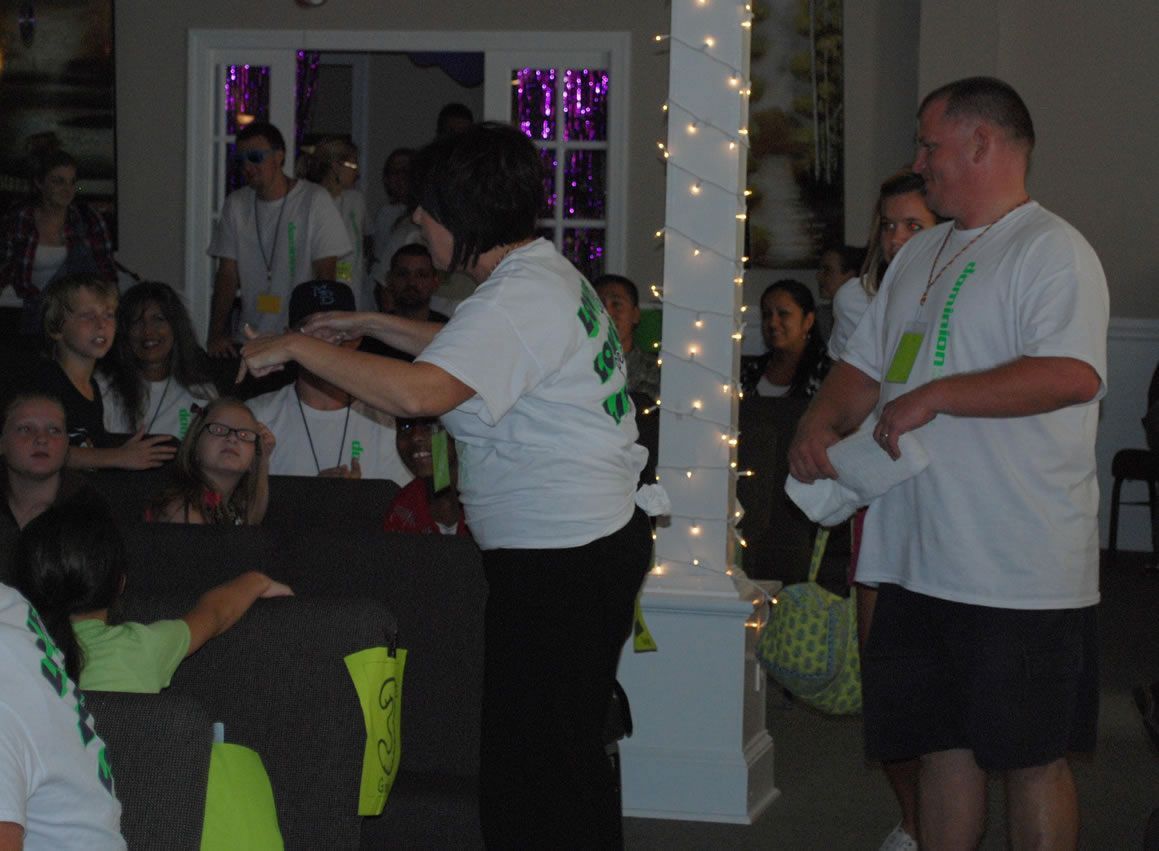 A man and a woman are standing in front of a crowd of people