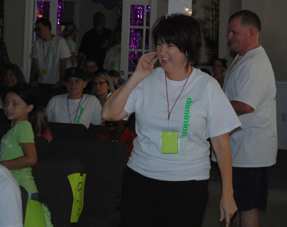 A woman wearing a white shirt with the word adventure on it