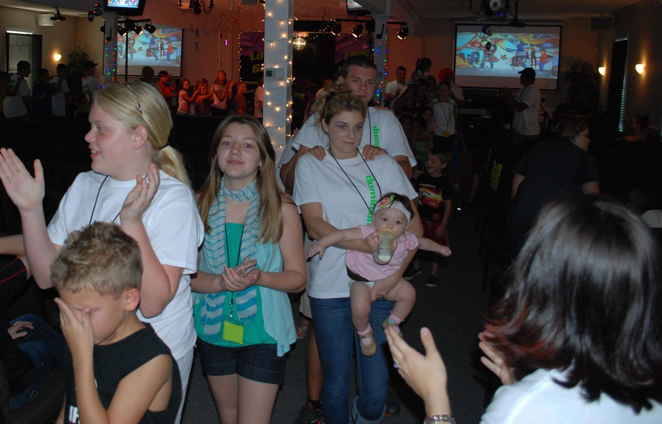 A woman is taking a picture of a group of people at a party