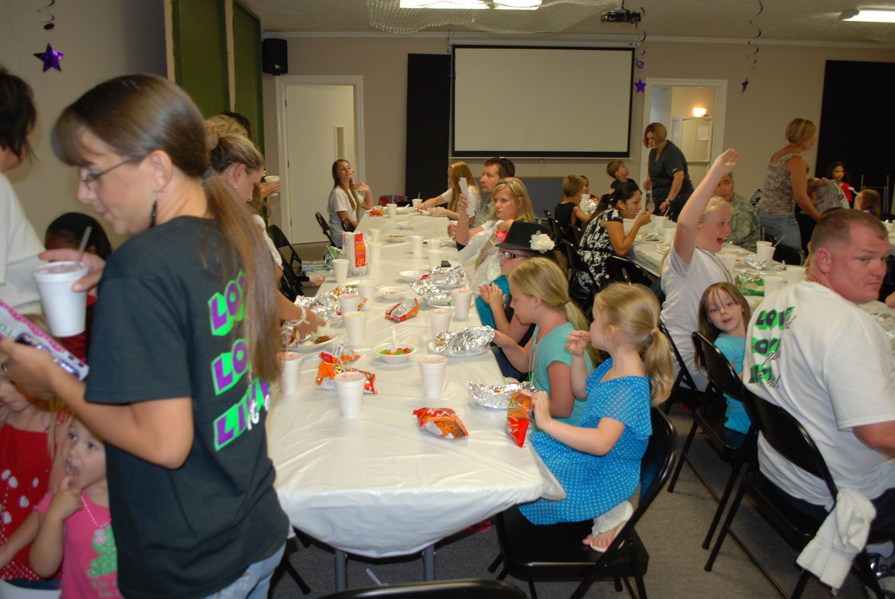 A woman wearing a black shirt that says bc on it