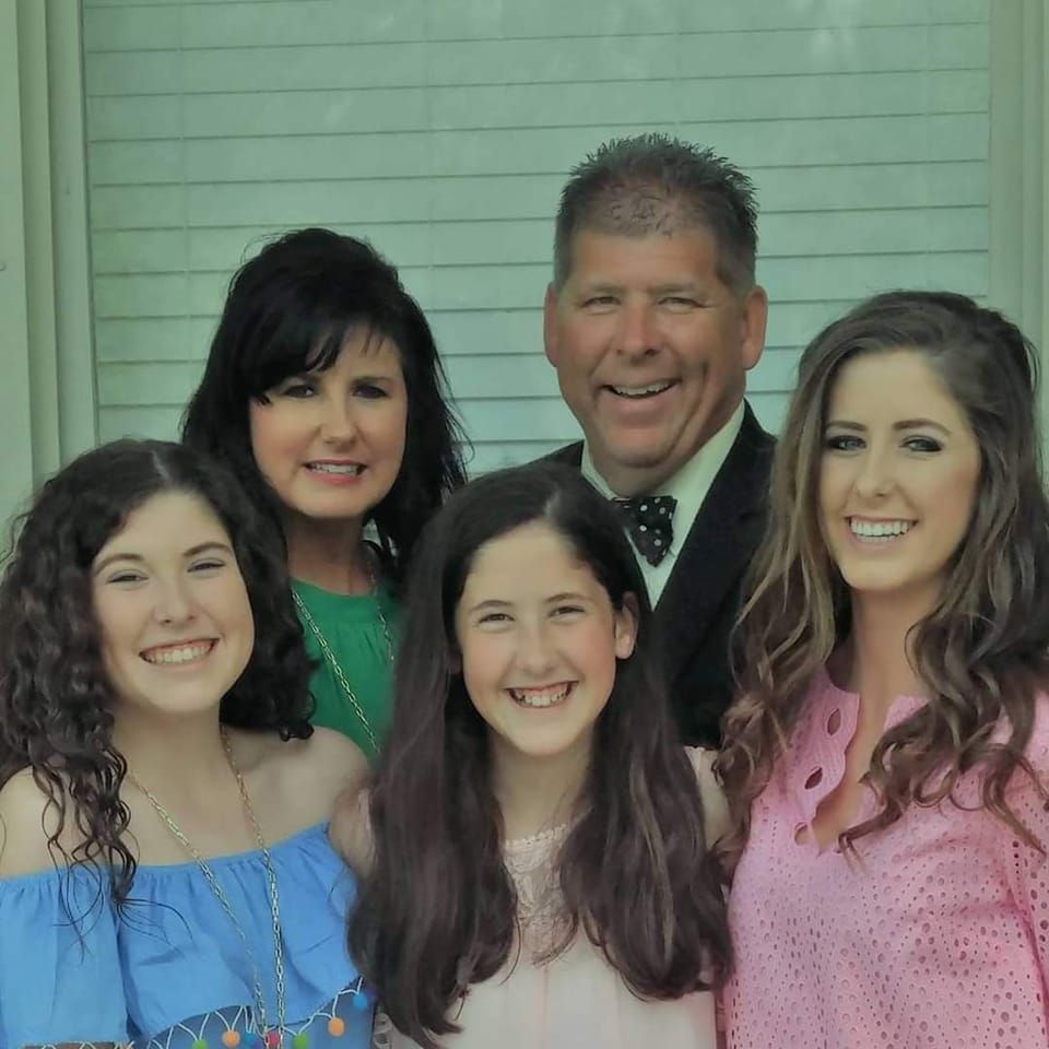 A group of people are posing for a picture and smiling