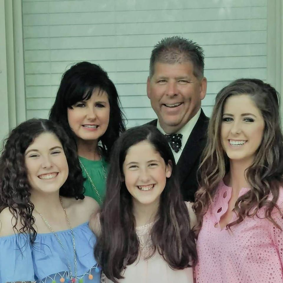 A group of people are posing for a picture and smiling