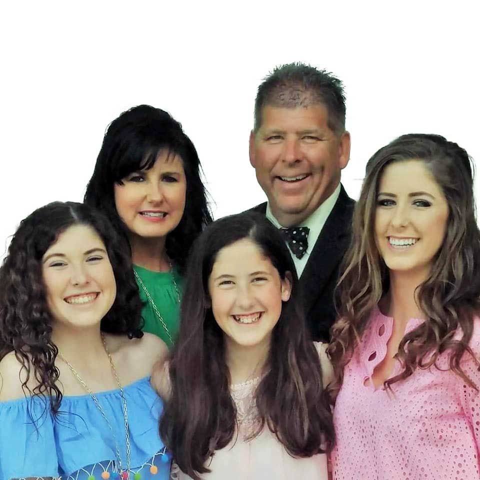 A group of people are posing for a picture and smiling