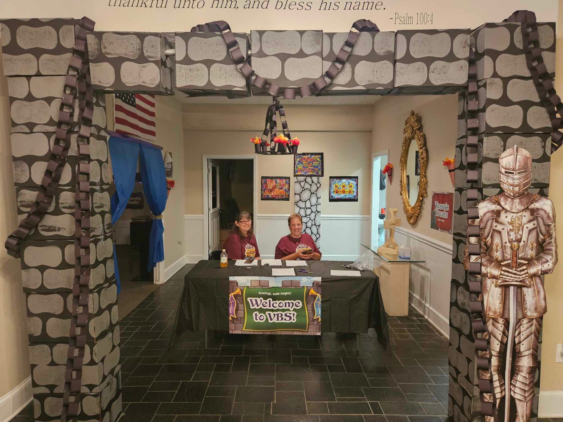 Two men are sitting at a table with a sign that says where 's the fun ?
