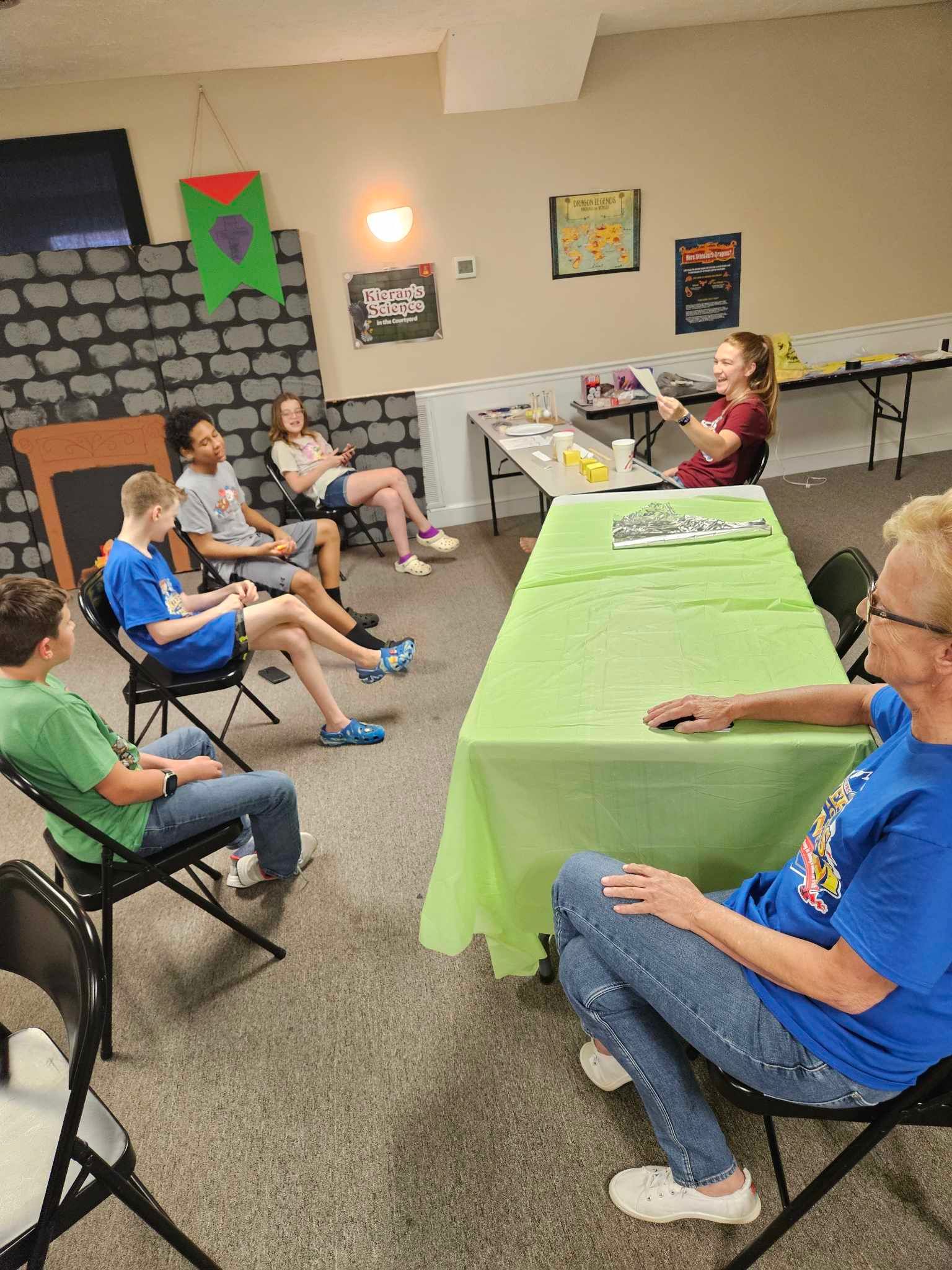 A group of people are sitting around a table in a room.