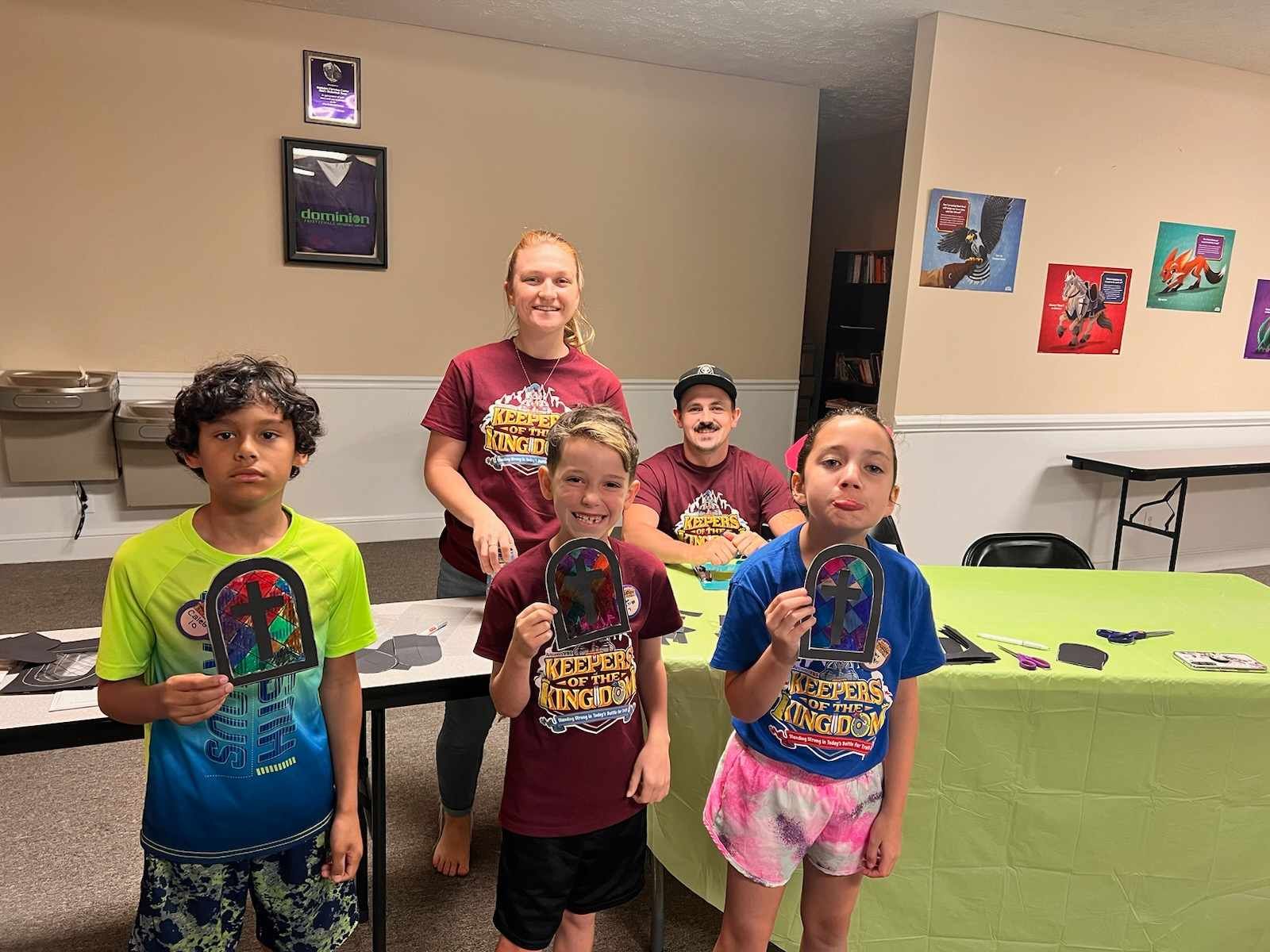 A group of children are posing for a picture in a room.