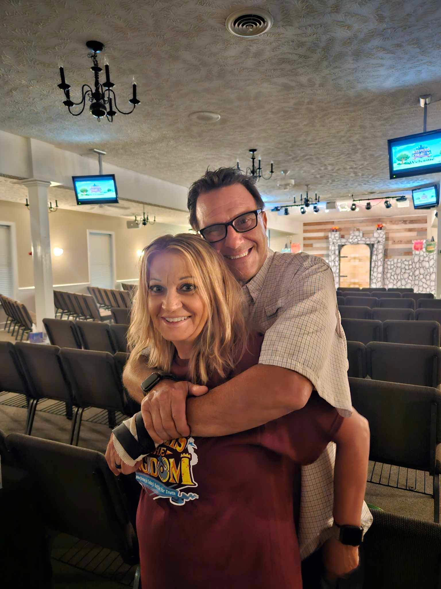 A man is hugging a woman in a church.