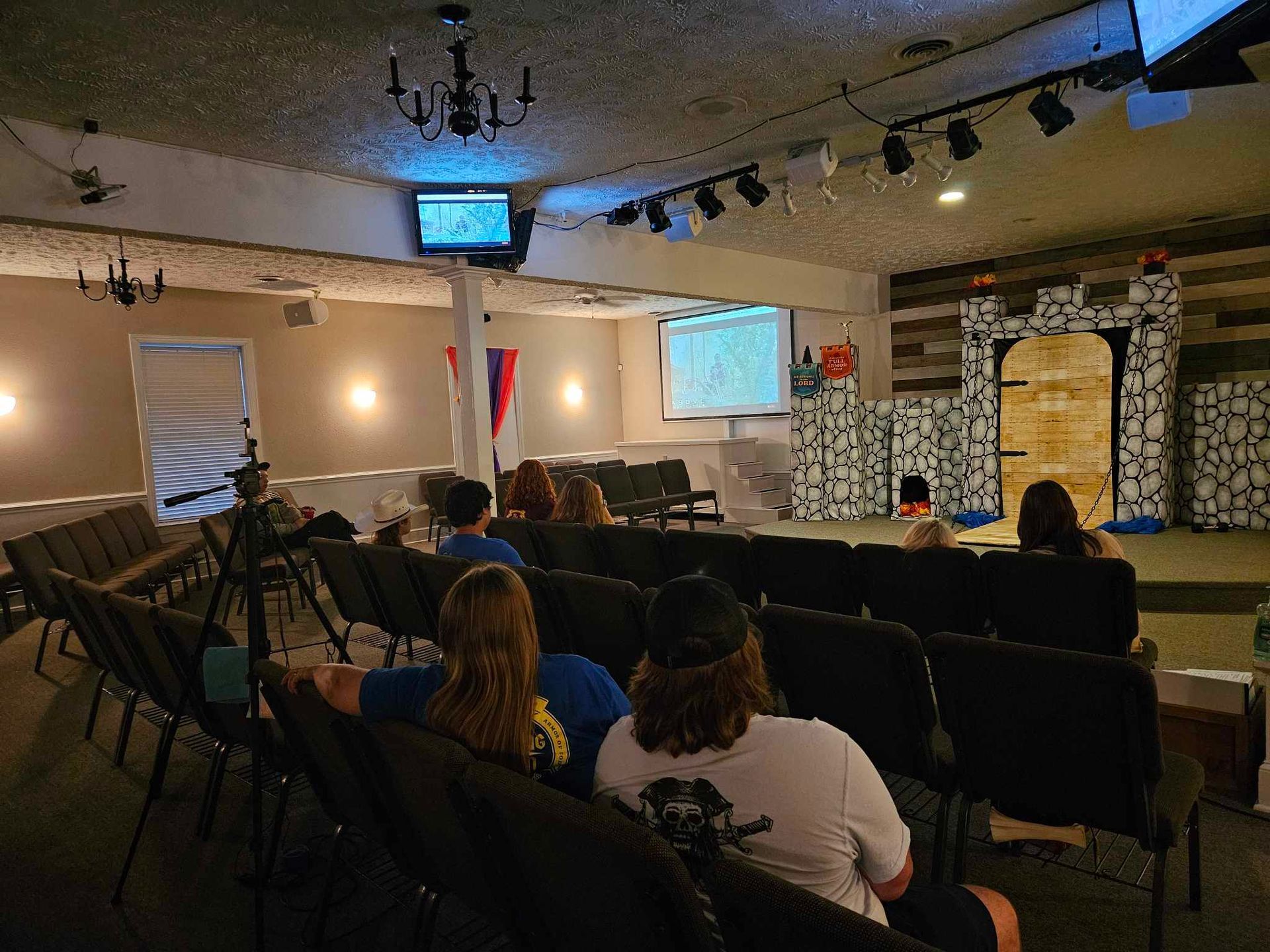 A group of people are sitting in a theater watching a movie.