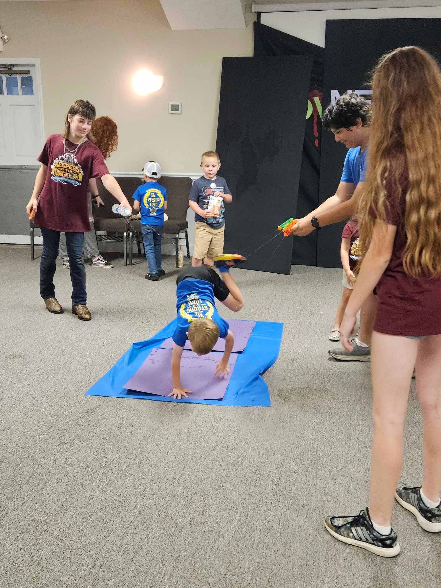 children playing with mat on floor