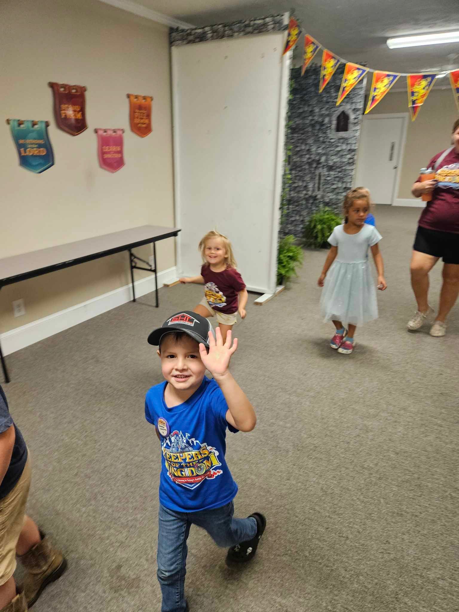 A group of children are standing in a room.