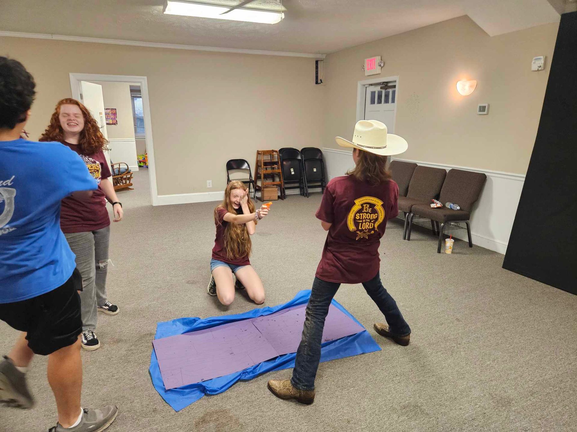 A group of people are playing a game in a room.