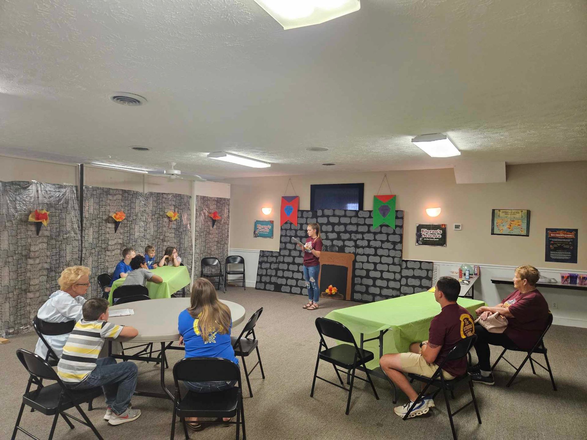 A group of people are sitting at tables in a room.