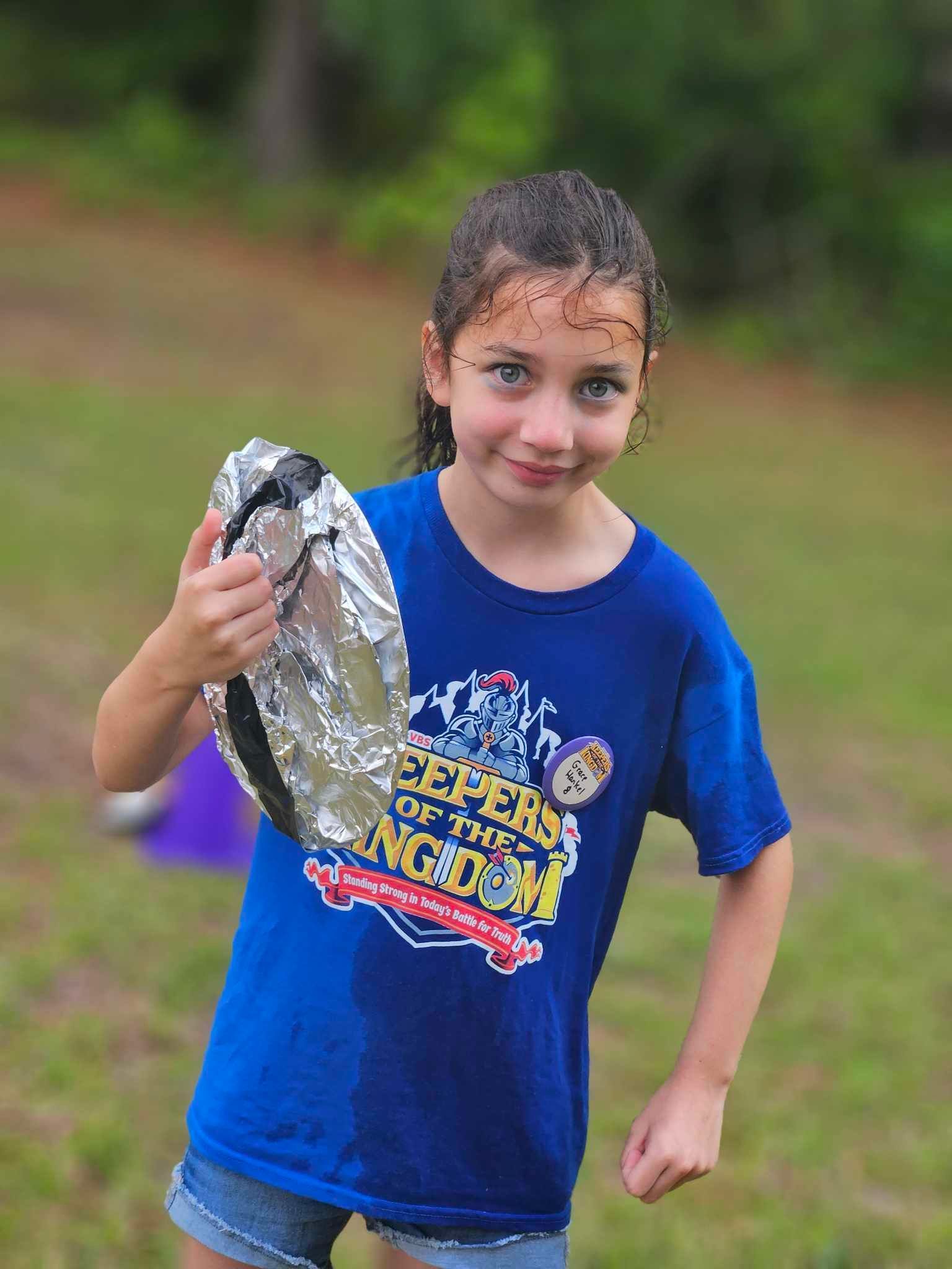 little girl showing off her artwork