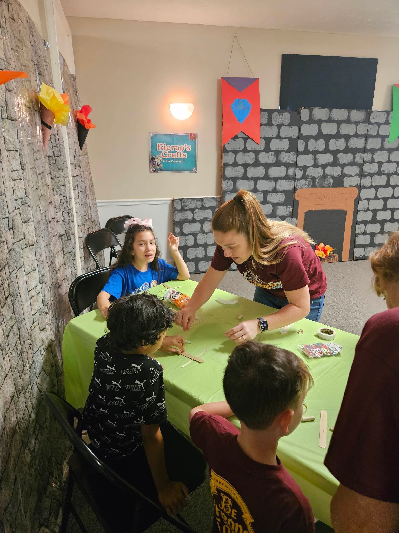 A group of children are sitting at a table playing a game.