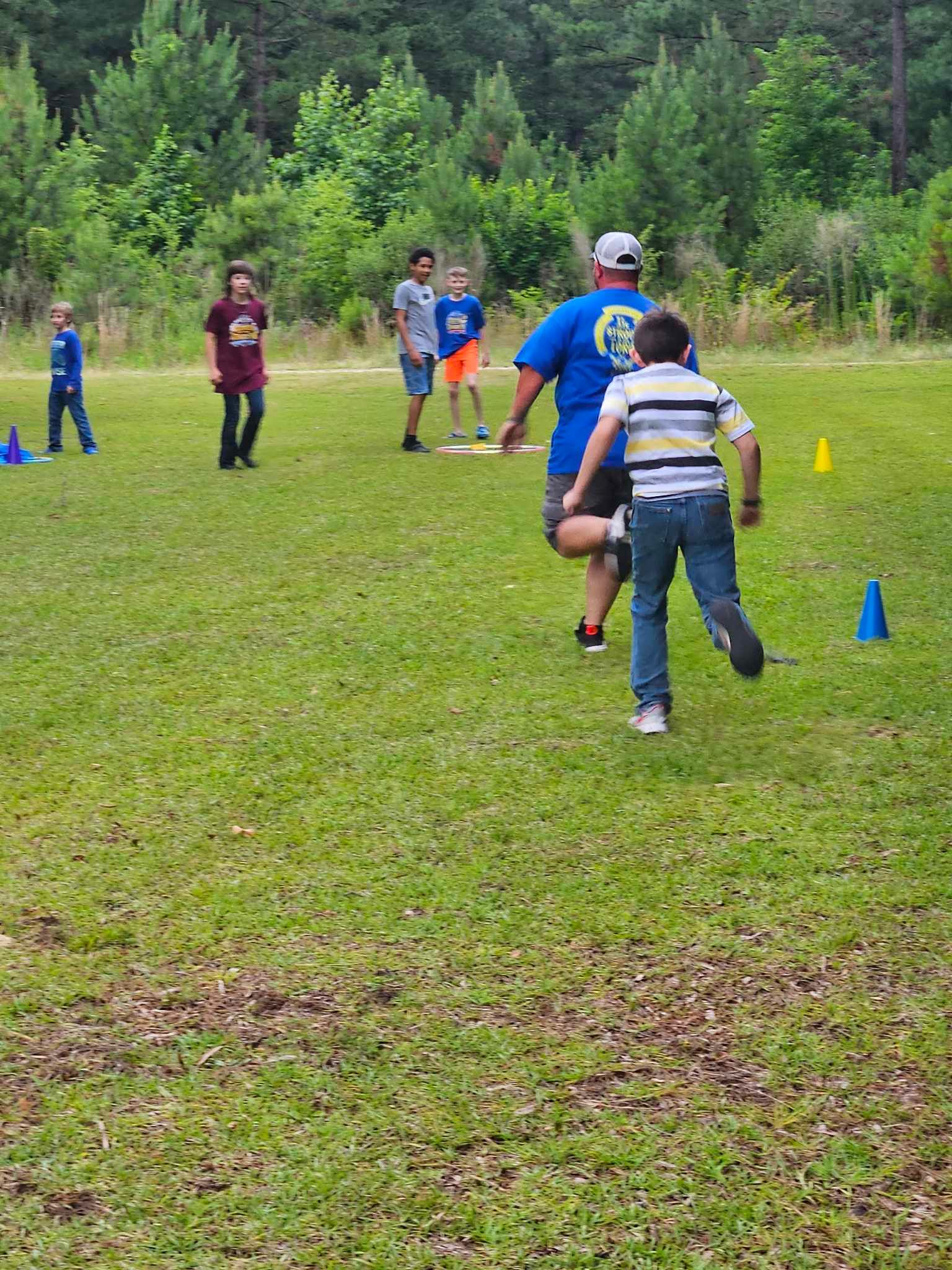 A group of people are playing soccer in a field.