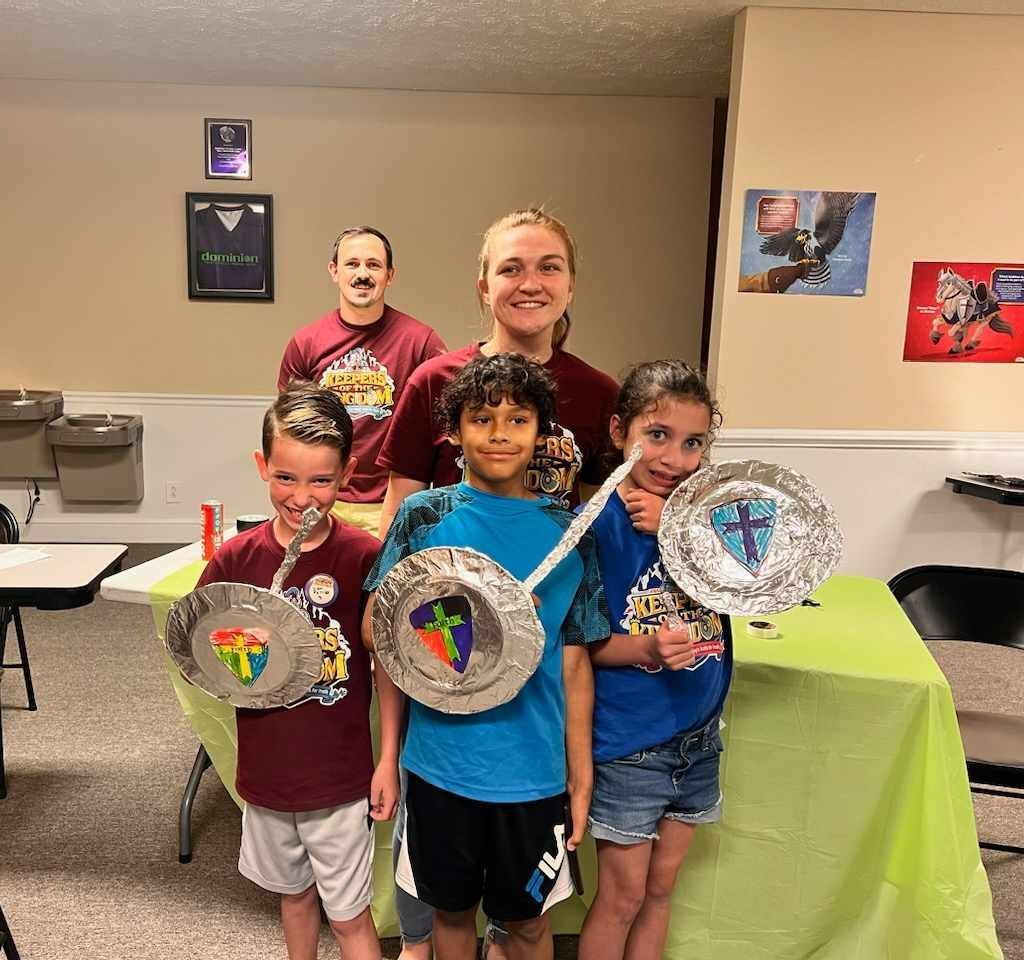 A group of children are posing for a picture while holding paper plates
