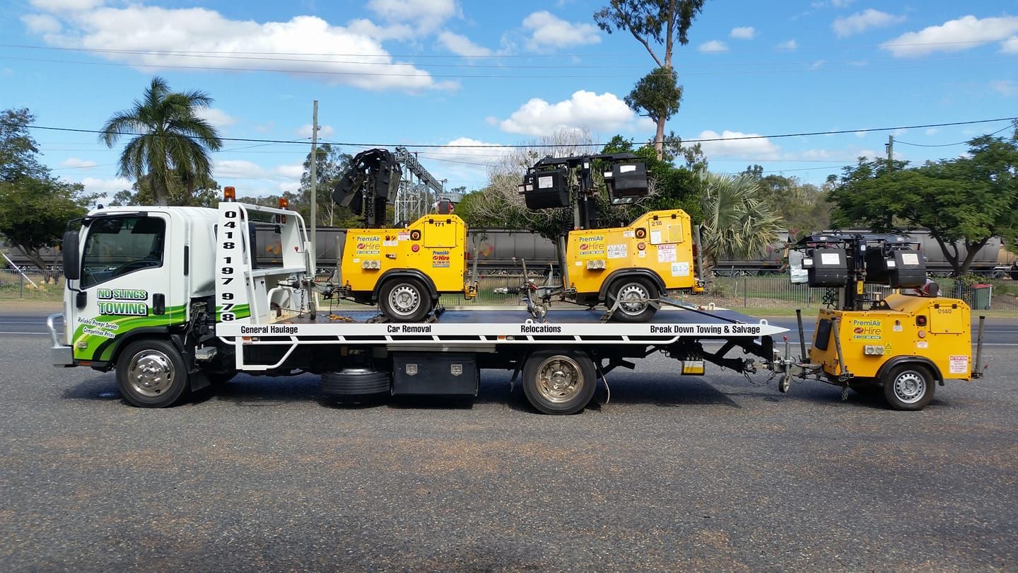A Flatbed Truck With Three Yellow and Black Construction Lights on the Back — No Slings Towing in Glendale, QLD