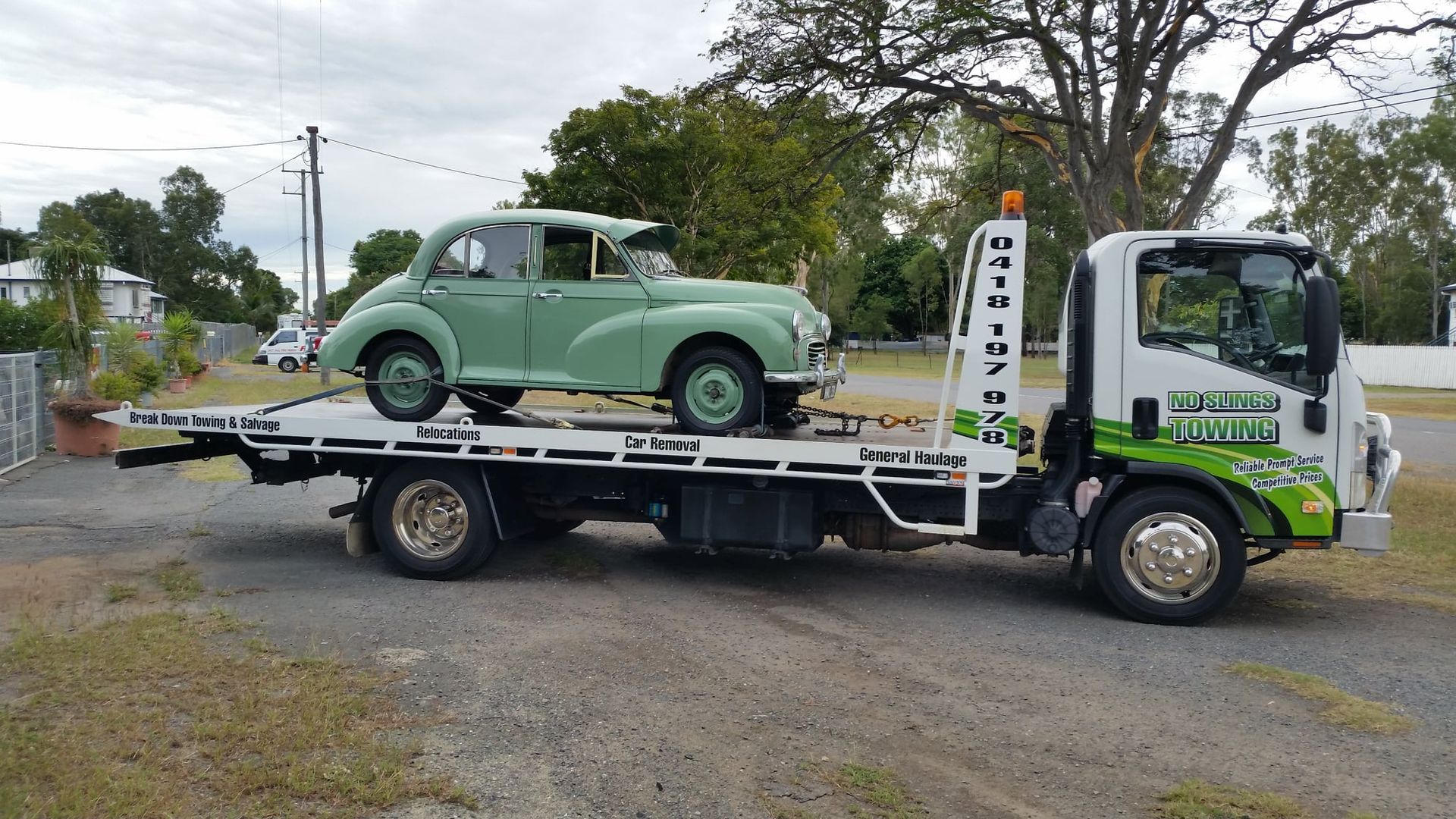 Green Vintage Car Loaded on a Tow Truck — No Slings Towing in Glendale, QLD