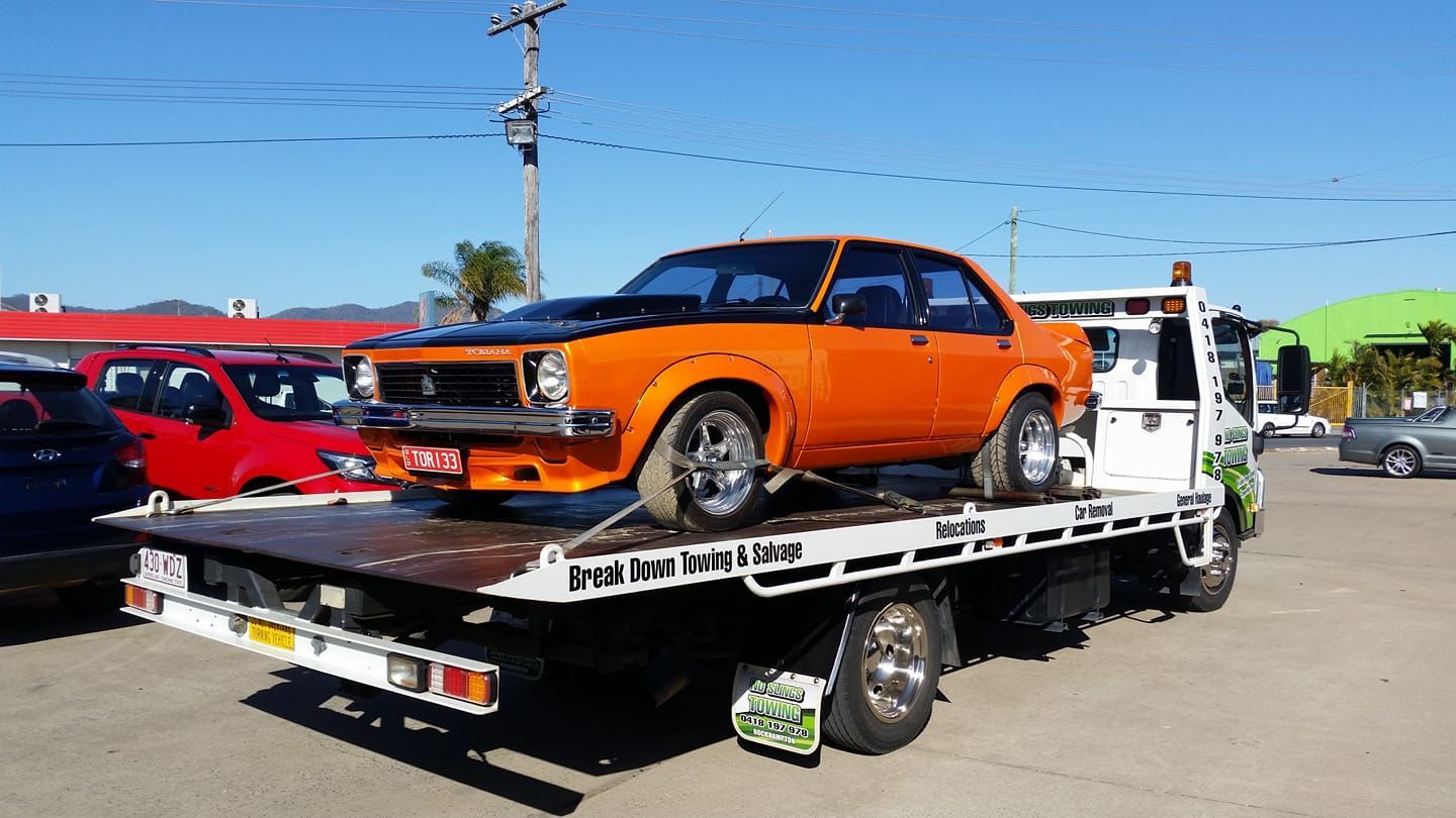 Orange Classic Car Loaded on a Flatbed Tow Truck — No Slings Towing in Glendale, QLD