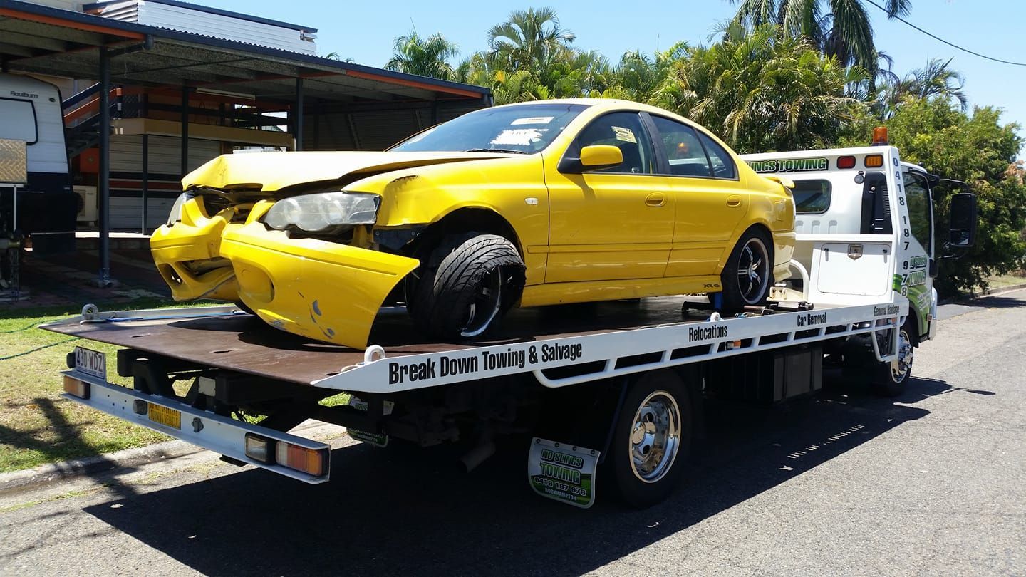 Yellow Car With Front-end Damage Loaded on a Tow Truck — No Slings Towing in Glendale, QLD