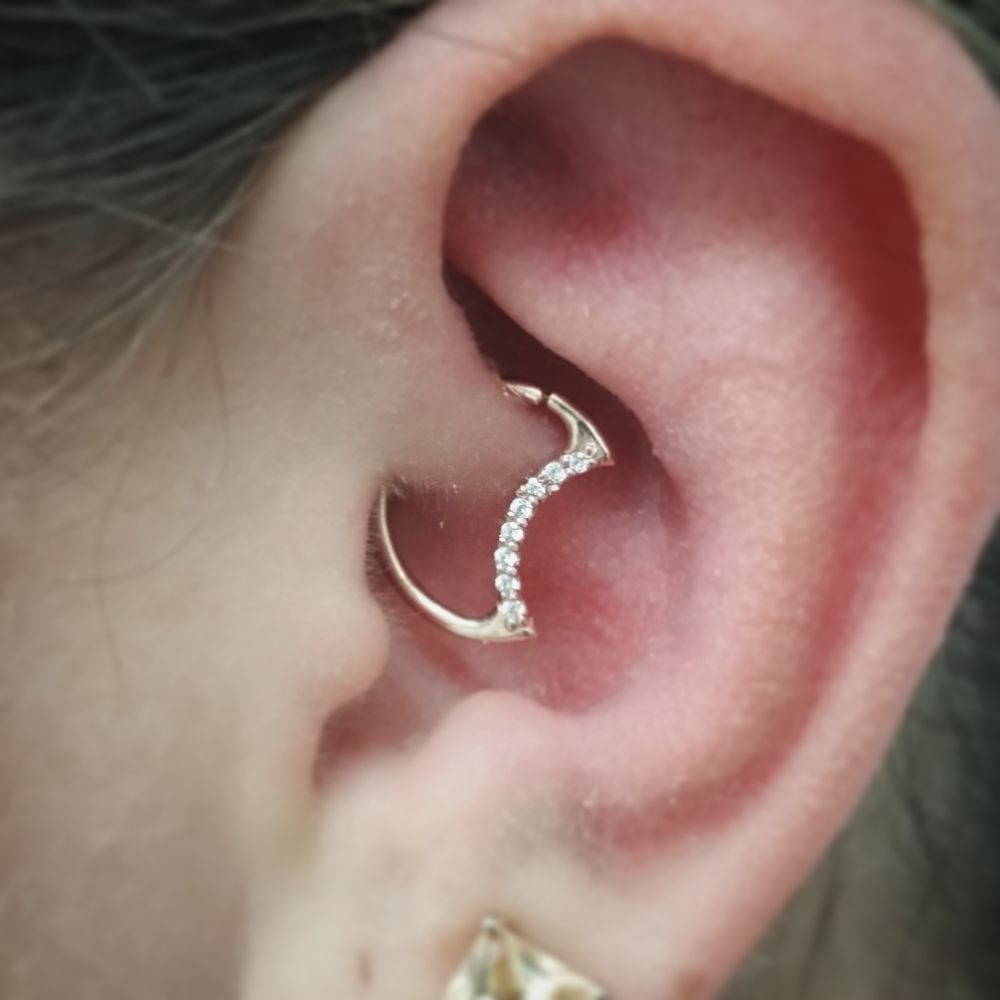 A close up of a woman 's ear with a ring in it