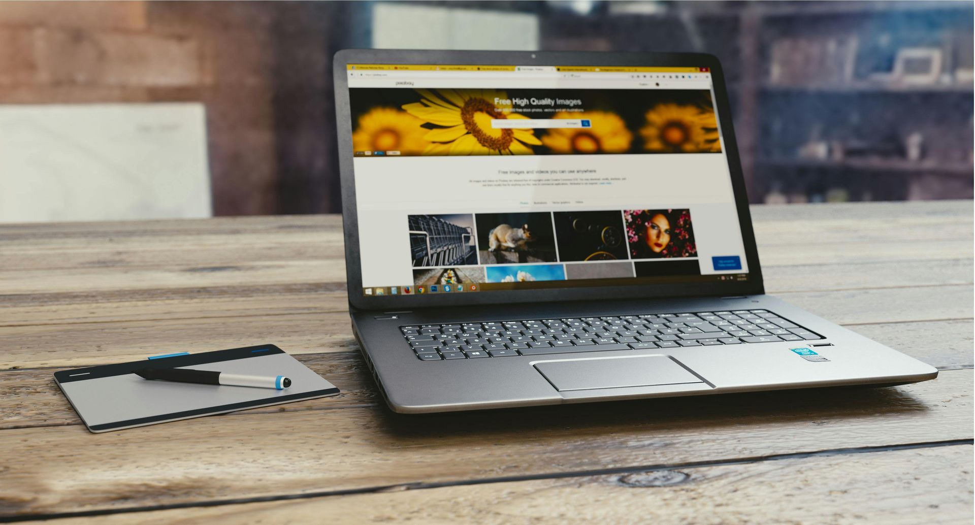 A laptop computer is sitting on a wooden table.