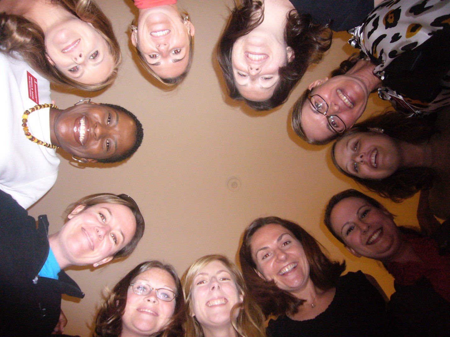A group of women are standing in a circle and smiling