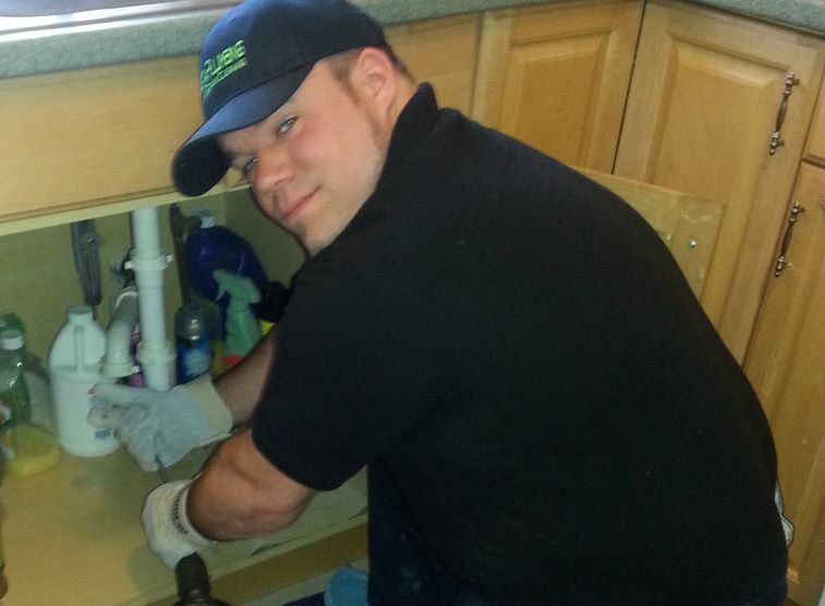 InstaPlumbing technician at work under sink