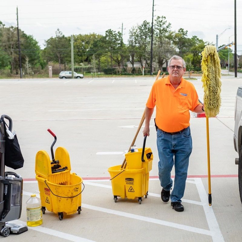 Man Holding Cleaning Tools