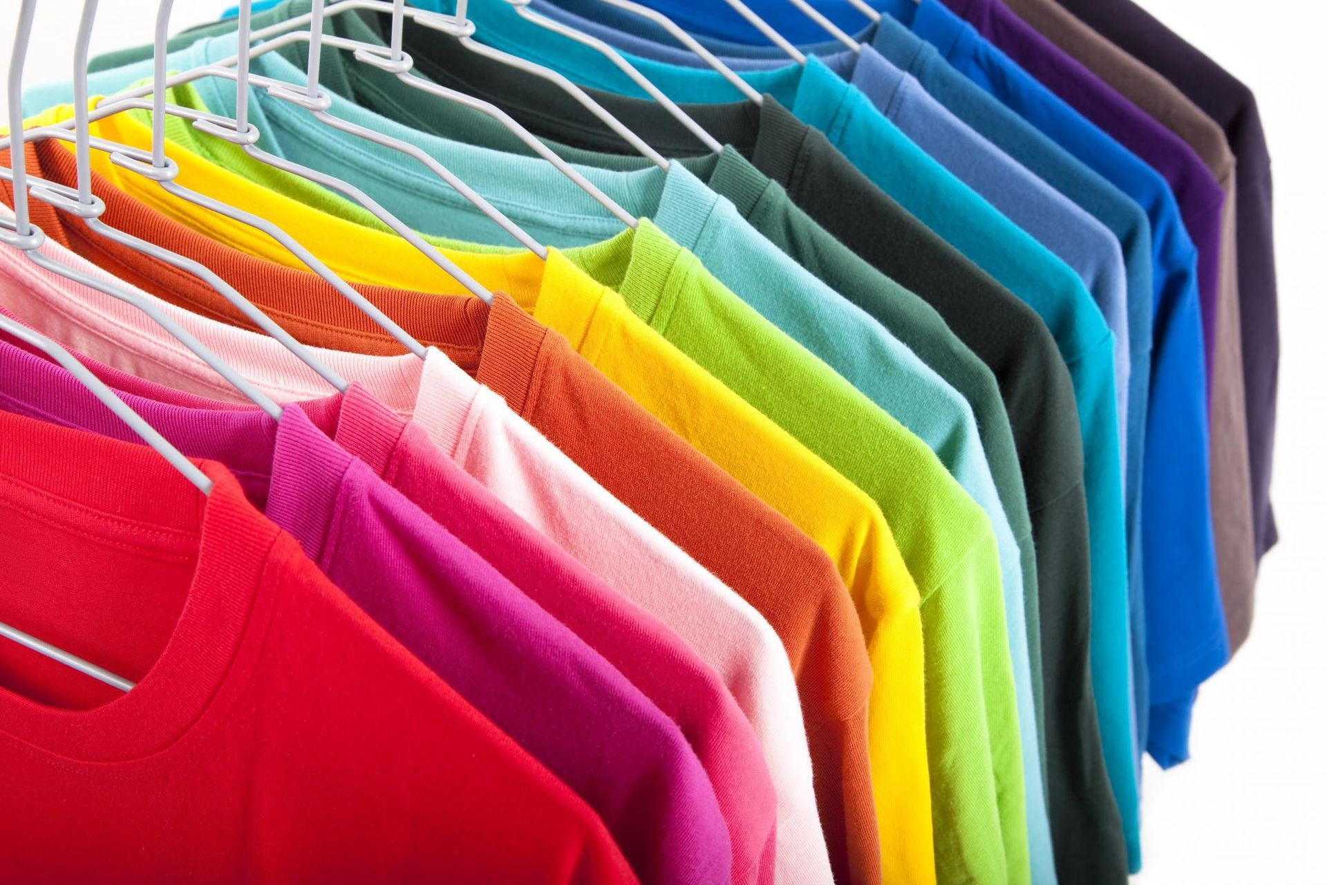 a rack of colorful shirts on a white background
