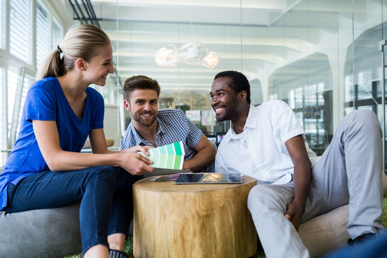 a group of people sitting around a wooden table