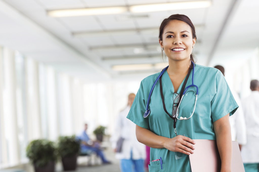 Female nurse wearing blue scrubs.