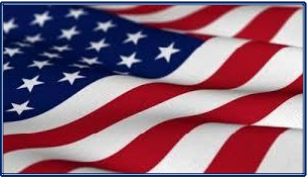 American flag waving in the wind against a clear blue sky.