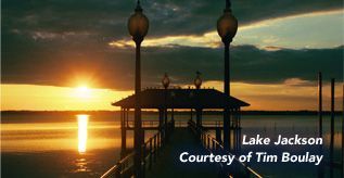 Sunset over Lake Jackson, silhouette of a pier with lights, courtesy of Tim Boulay.