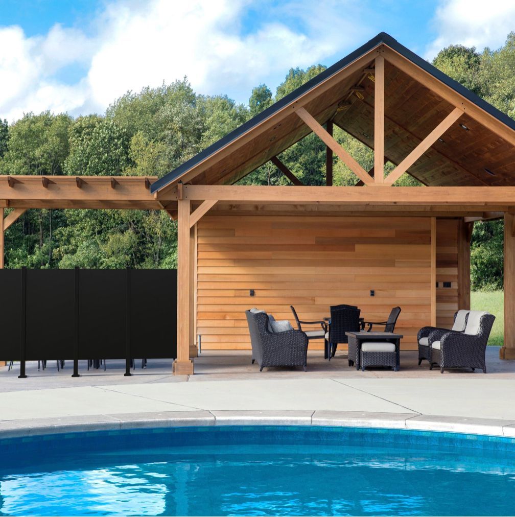 A wooden house with a swimming pool in front of it