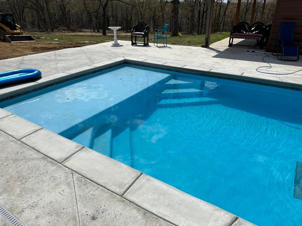 A large swimming pool with stairs leading up to it.