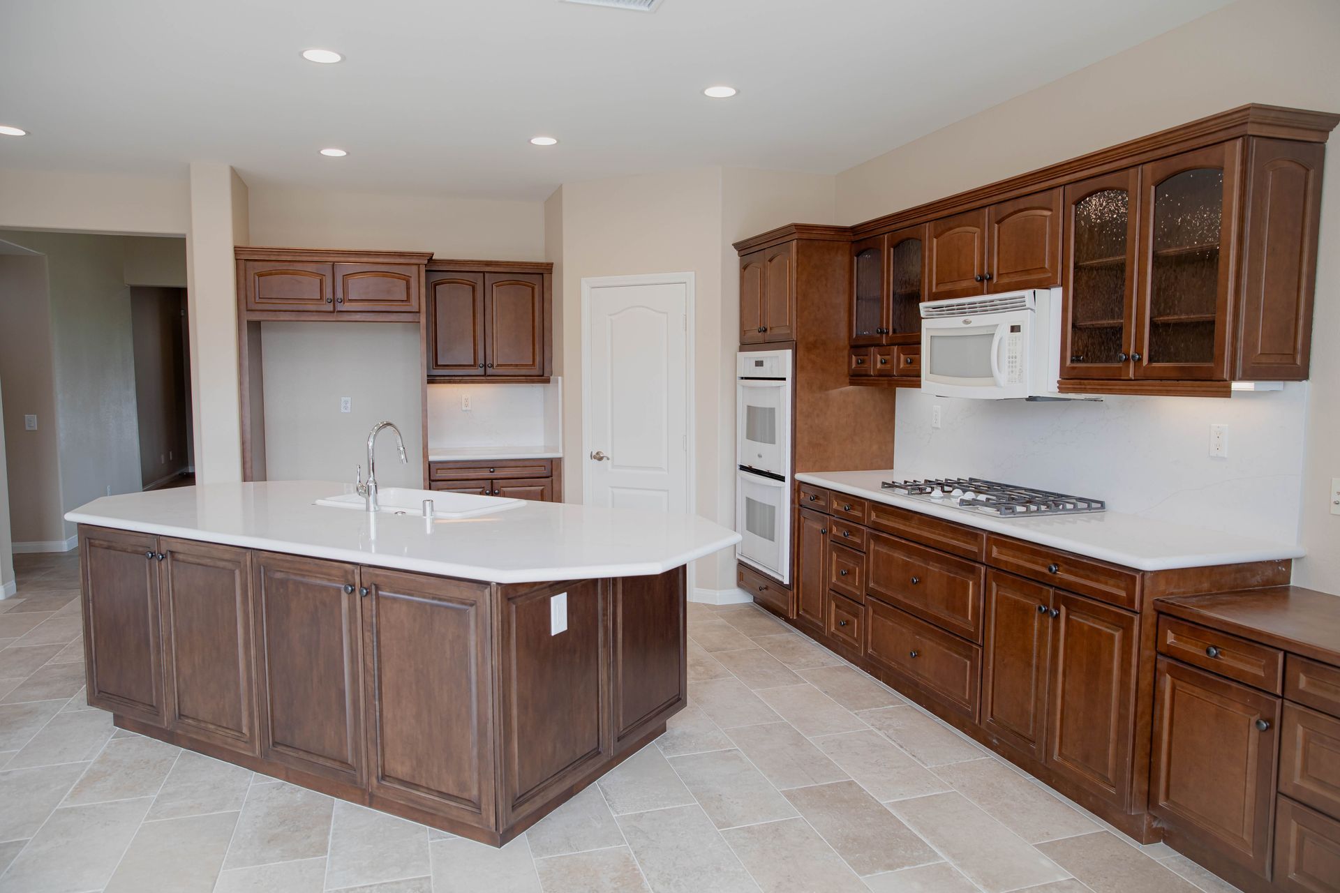 A kitchen with wooden cabinets and a large island in Vista, California.