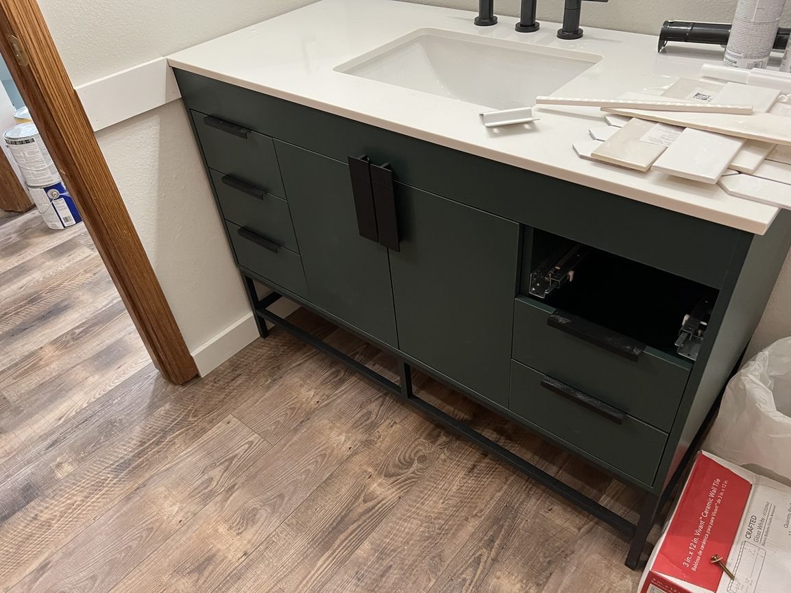 A bathroom vanity with a sink and drawers underneath it.