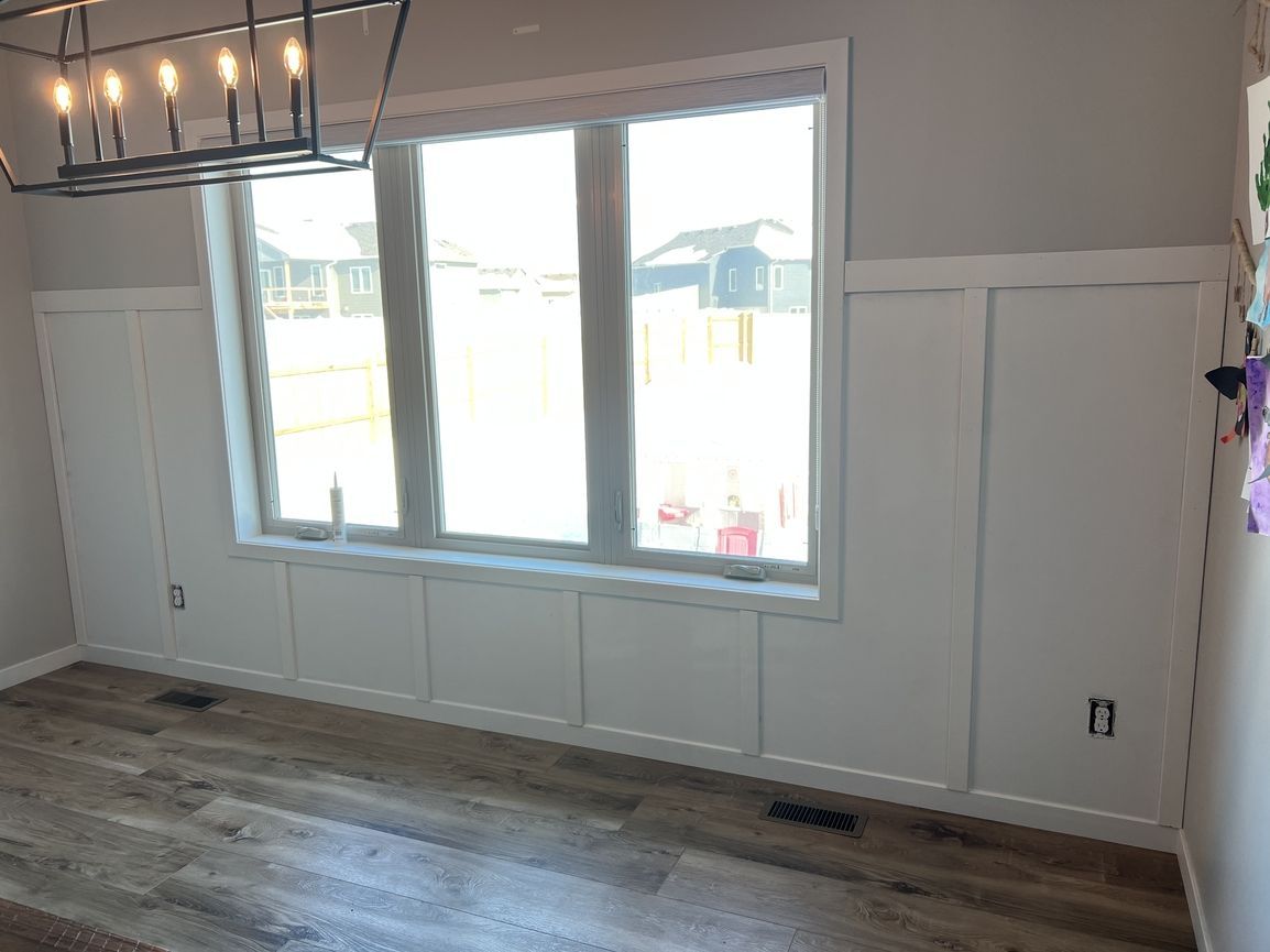A room with a lot of windows and a chandelier.