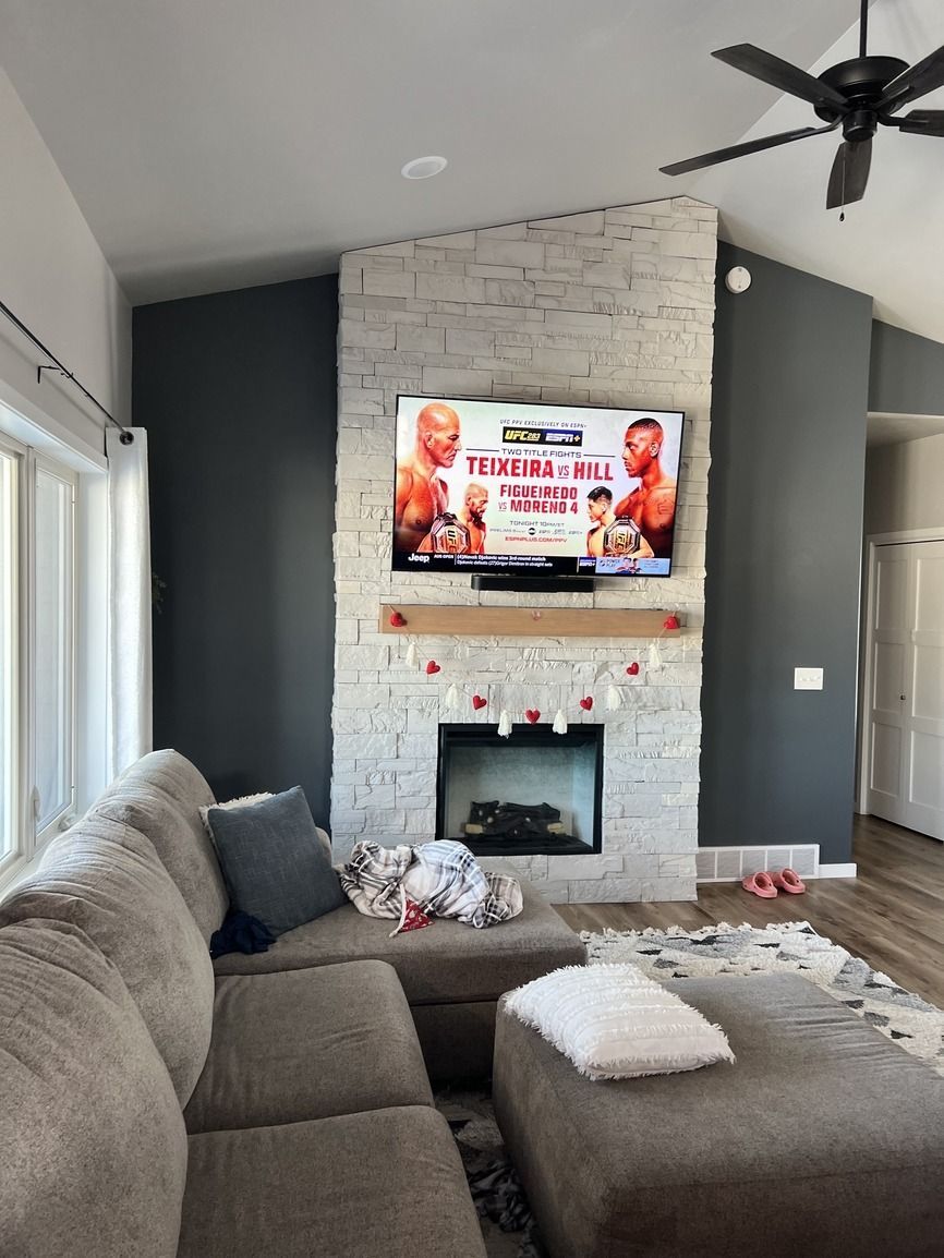 A living room with a fireplace and a flat screen tv