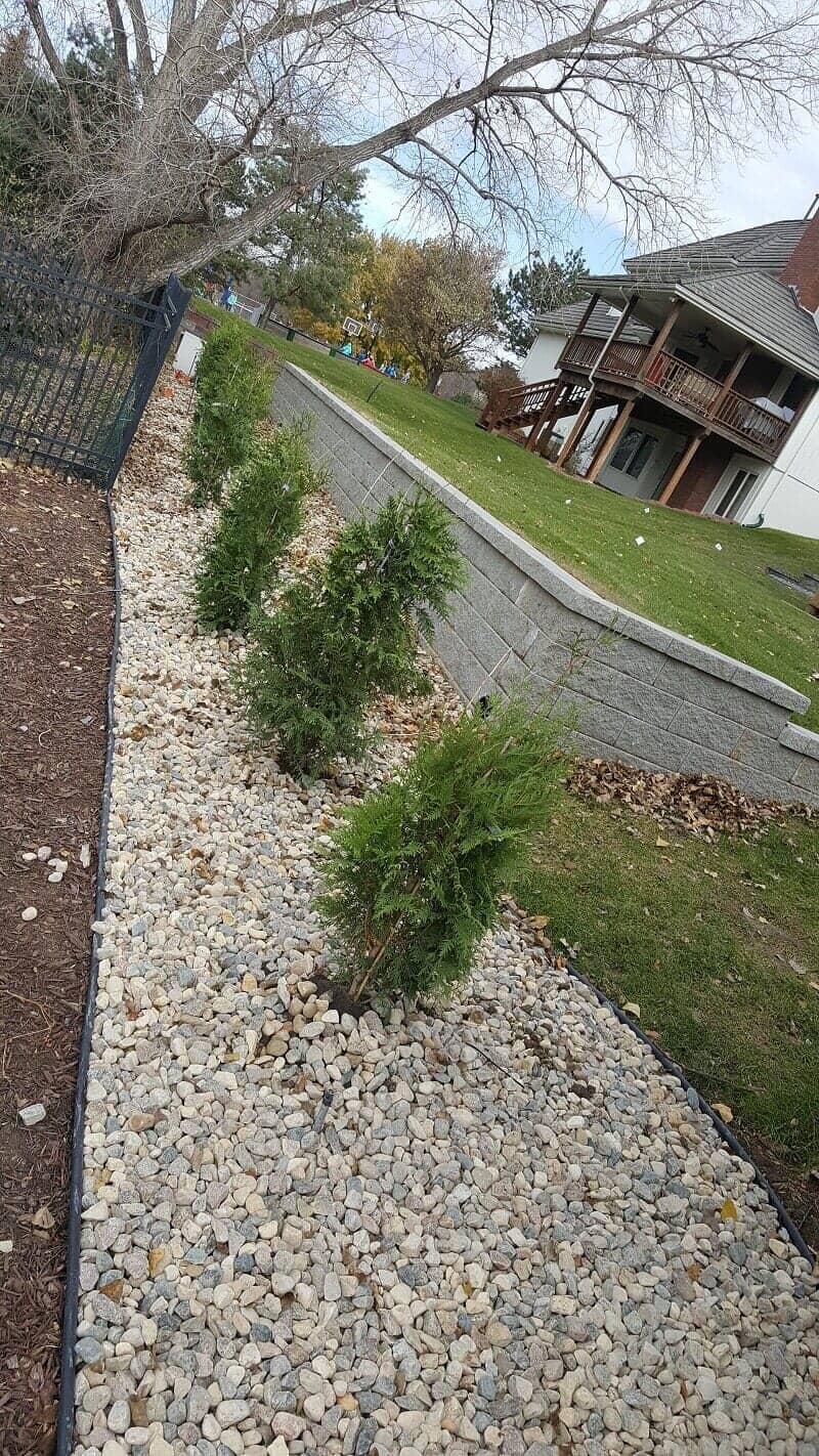 Stone Landscape Bed with Plants — Omaha, NE — Omaha Lawnscaping Solutions