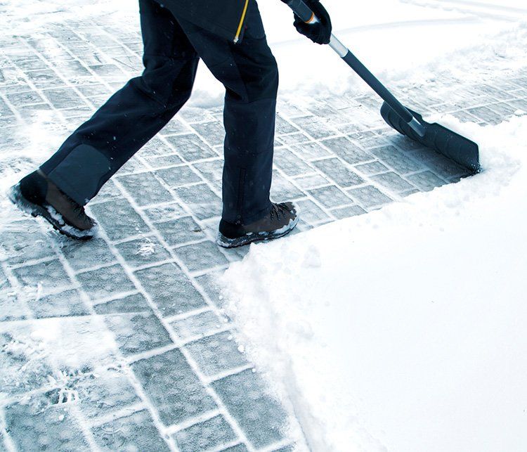Cleaning the Snow with Shovel — Omaha, NE — Omaha Lawnscaping Solutions