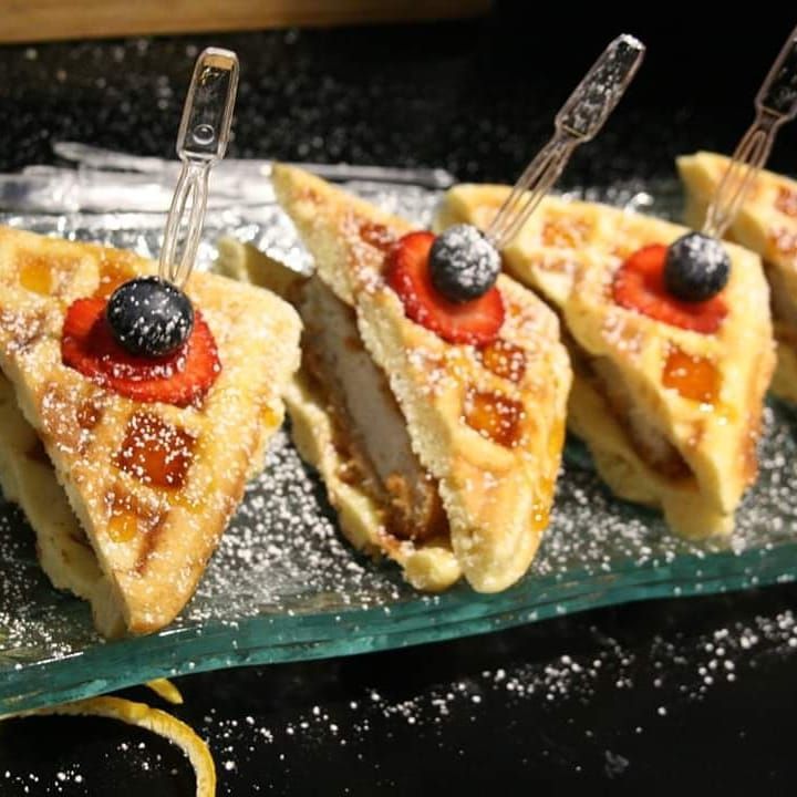 A plate of desserts with strawberries and blueberries on them