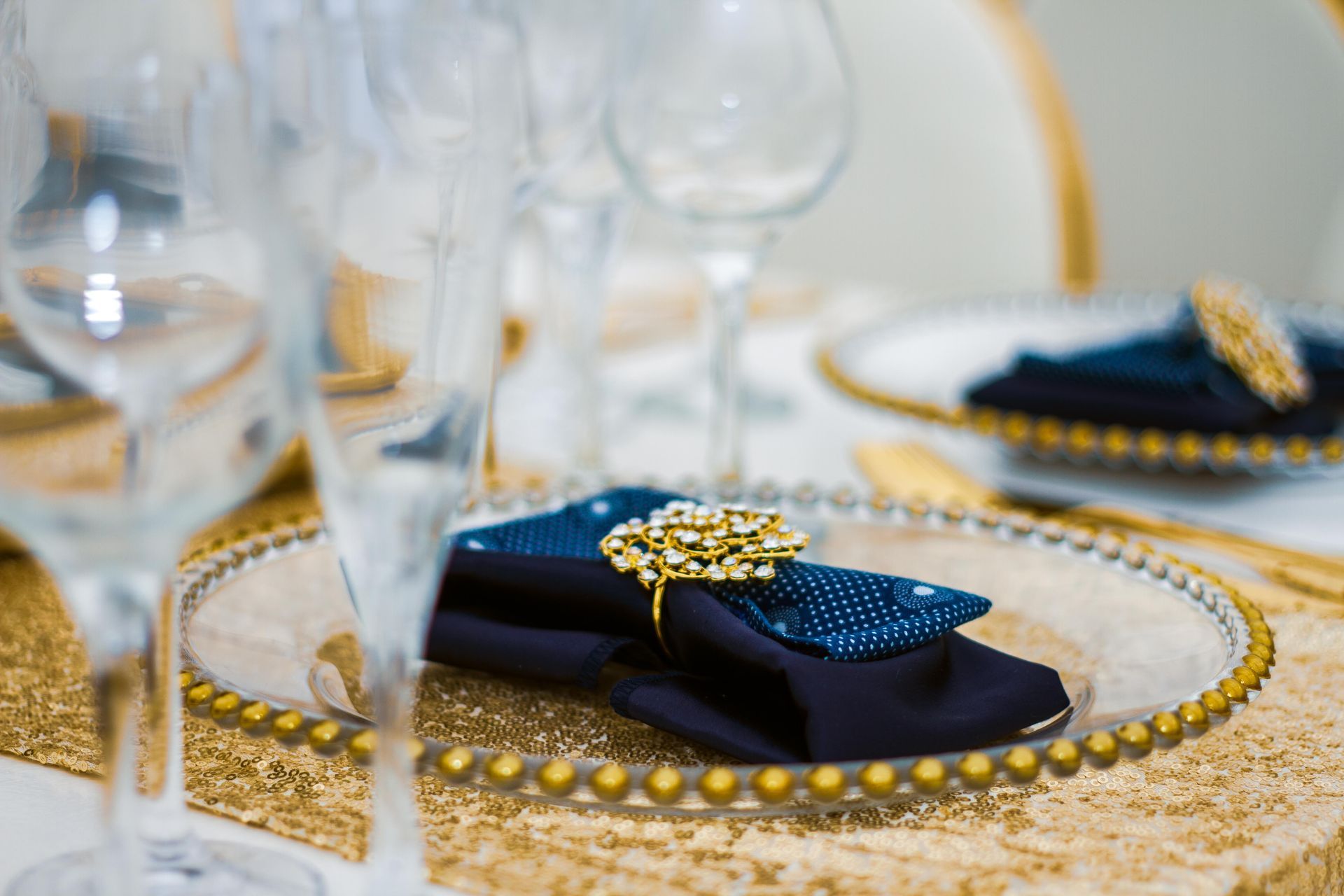 A napkin is sitting on a glass plate on a table.